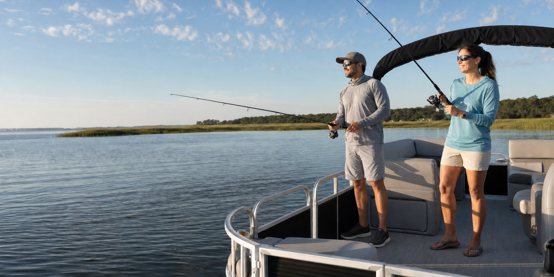 A man and woman fishing safely inside the railing of a pontoon boat on a Northeast Florida waterway